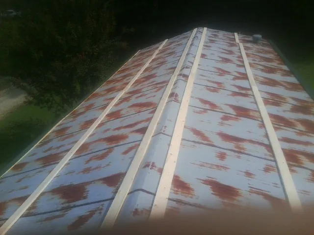 Rusted metal roof panels with new wood purlins before replacement — Storm Damage Roof Repair in Bernardsville by Roofing Brothers